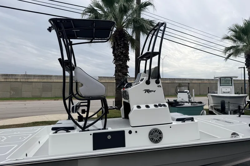 Slide: The Image of 2026 SCB R24 boat with elevated seating, parked near palm trees. - 6