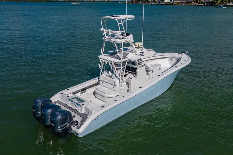 Slide: The Image of 2018 Yellowfin 36 Offshore boat with triple Yamaha engines on calm water. - 11
