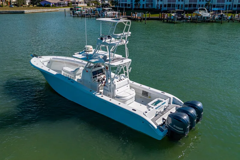 Slide: The Image of 2018 Yellowfin 36 Offshore boat with triple Yamaha engines on calm water. - 12