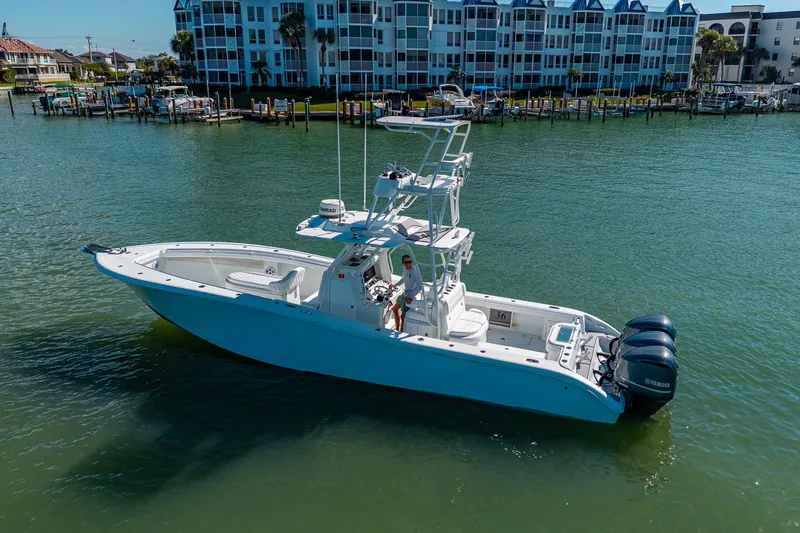 Slide: The Image of 2018 Yellowfin 36 Offshore boat on water near residential buildings. - 13