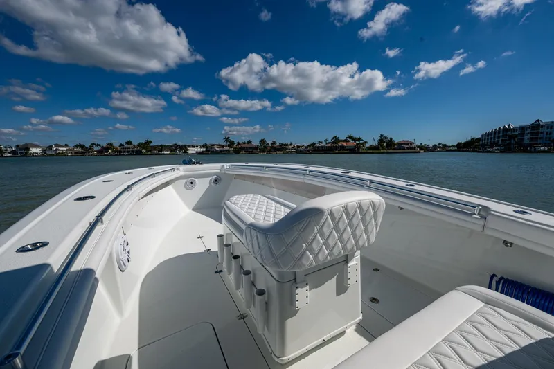 Slide: The Image of 2018 Yellowfin 36 Offshore boat with white seating, cruising on a sunny day. - 14