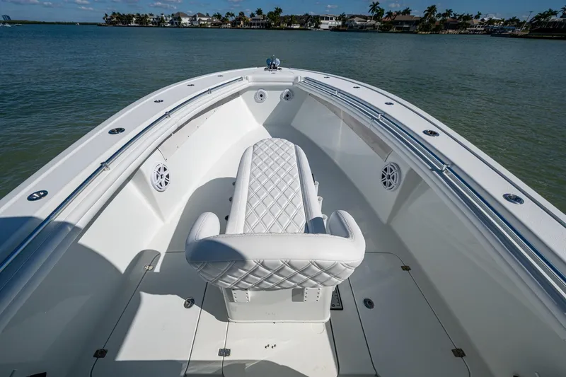 Slide: The Image of 2018 Yellowfin 36 Offshore boat with white seating, on calm water. - 15