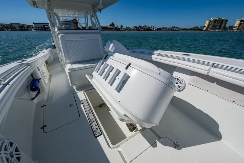 Slide: The Image of 2018 Yellowfin 36 Offshore boat interior with seating and open water view. - 18