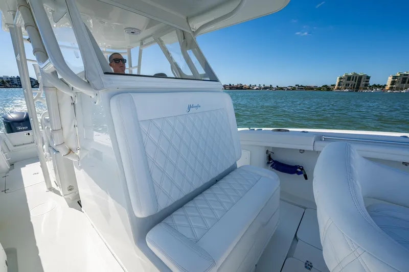 Slide: The Image of 2018 Yellowfin 36 Offshore boat interior with white seating, on a sunny day. - 23