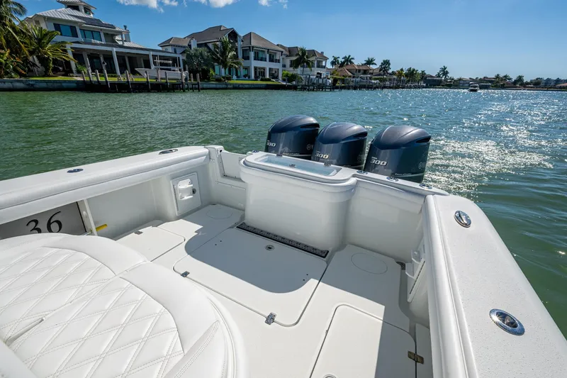 Slide: The Image of 2018 Yellowfin 36 Offshore boat with triple 300 horsepower engines on a sunny waterfront. - 25