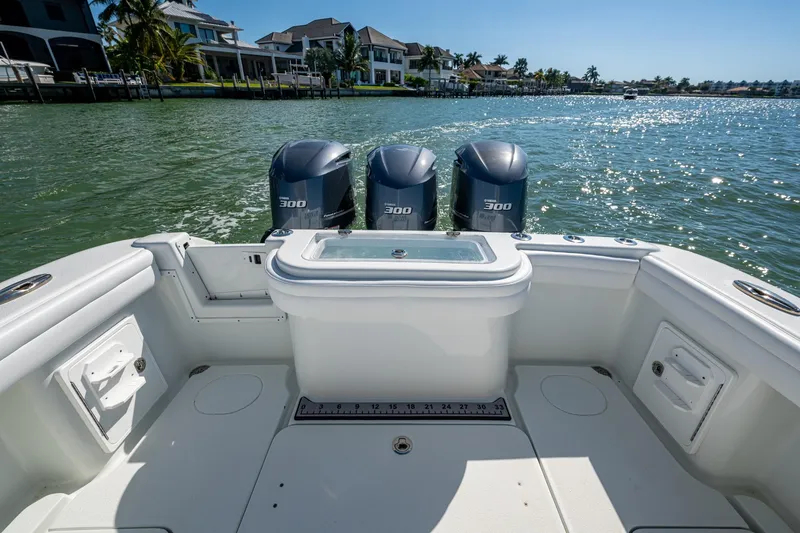 Slide: The Image of 2018 Yellowfin 36 Offshore boat with triple 300 horsepower engines on a sunny day. - 27