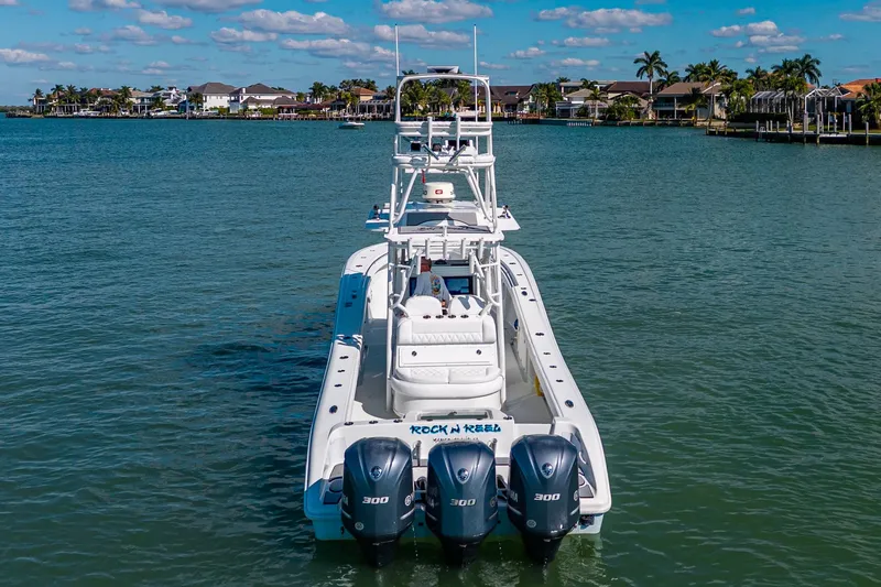Slide: The Image of 2018 Yellowfin 36 Offshore boat with triple 300 horsepower engines on a sunny day. - 3
