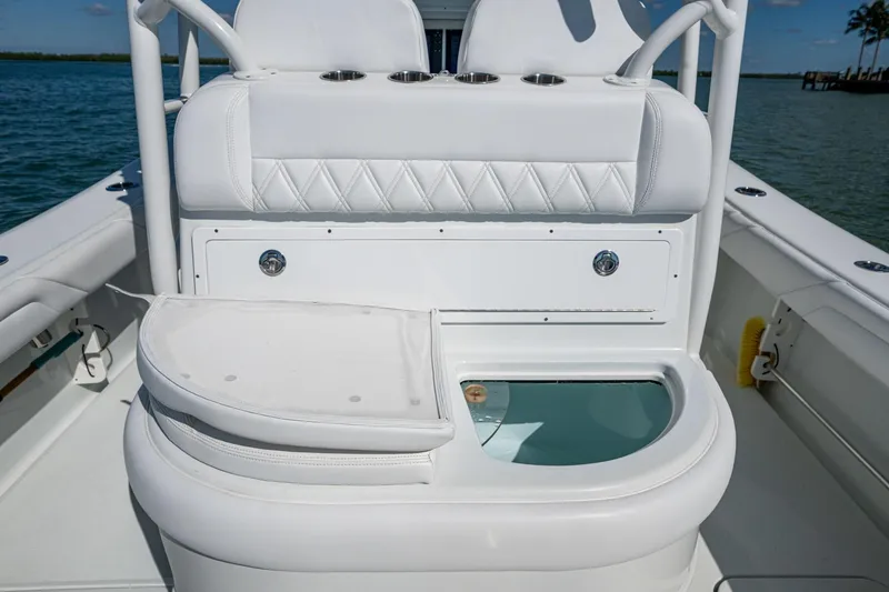Slide: The Image of 2018 Yellowfin 36 Offshore boat interior with white seating and storage compartment. - 32