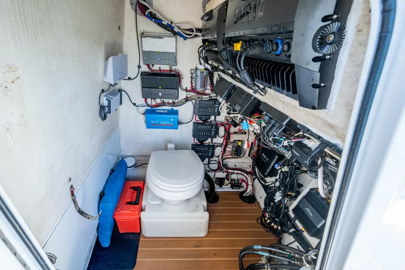 Slide: The Image of 2018 Yellowfin 36 Offshore boat interior with toilet and electrical systems. - 35