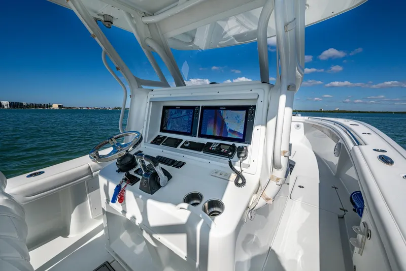 Slide: The Image of 2018 Yellowfin 36 Offshore boat cockpit with navigation screens and steering wheel. - 38