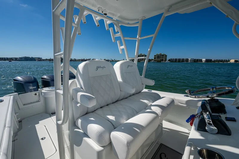 Slide: The Image of 2018 Yellowfin 36 Offshore boat interior with white seating and ocean view. - 39
