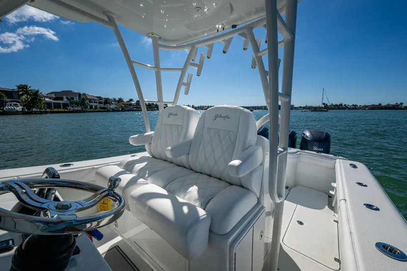 Slide: The Image of 2018 Yellowfin 36 Offshore boat interior with luxurious seating and steering wheel on a sunny day. - 40