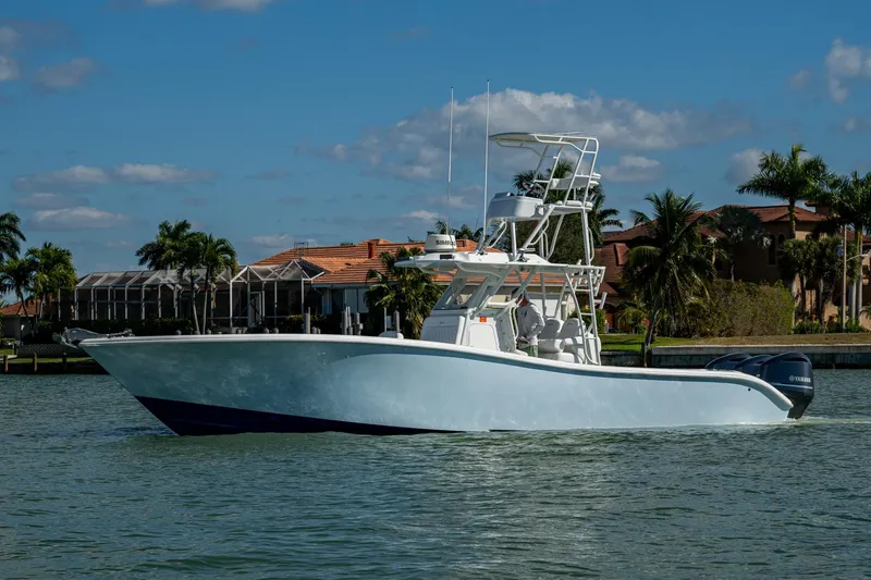 Slide: The Image of 2018 Yellowfin 36 Offshore boat cruising on a sunny day near waterfront homes. - 42