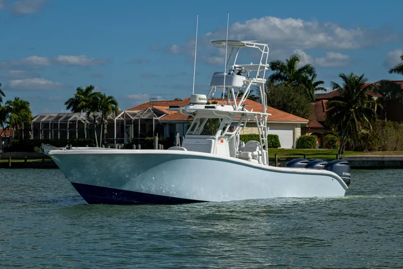 Slide: The Image of 2018 Yellowfin 36 Offshore boat cruising on a sunny day near waterfront homes. - 43