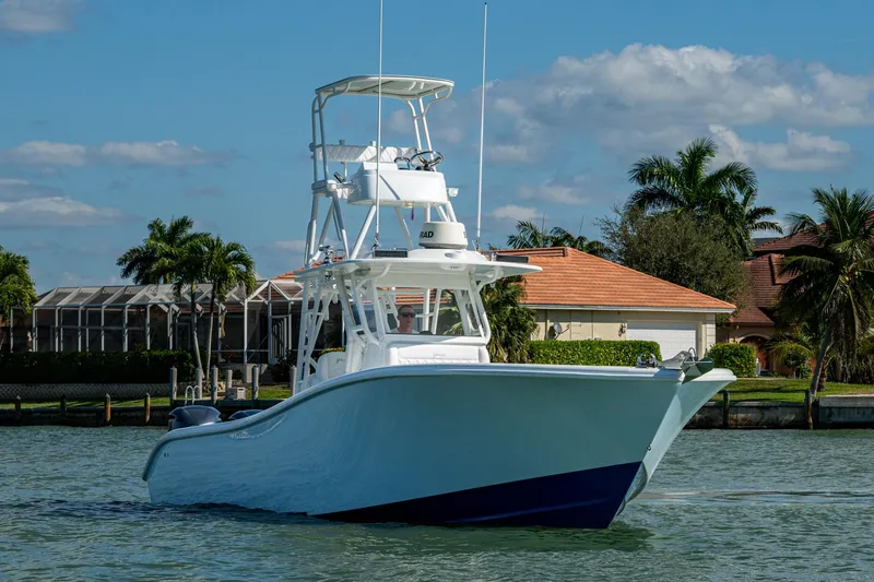 Slide: The Image of 2018 Yellowfin 36 Offshore boat on water, with tropical background and clear sky. - 46
