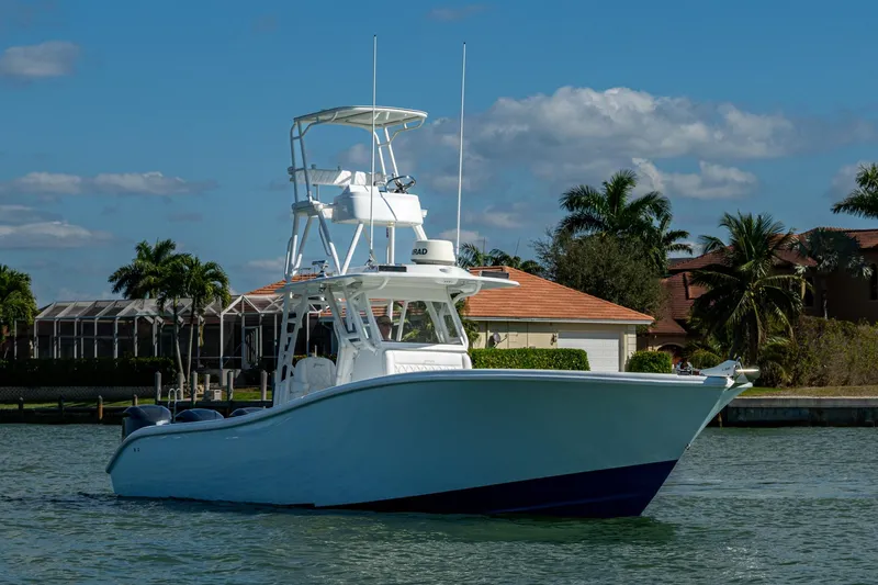 Slide: The Image of 2018 Yellowfin 36 Offshore boat on water, with tropical background and clear sky. - 47
