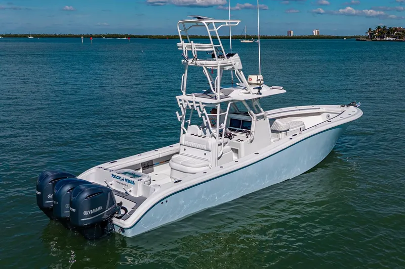 Slide: The Image of 2018 Yellowfin 36 Offshore boat with triple Yamaha engines on calm water. - 5