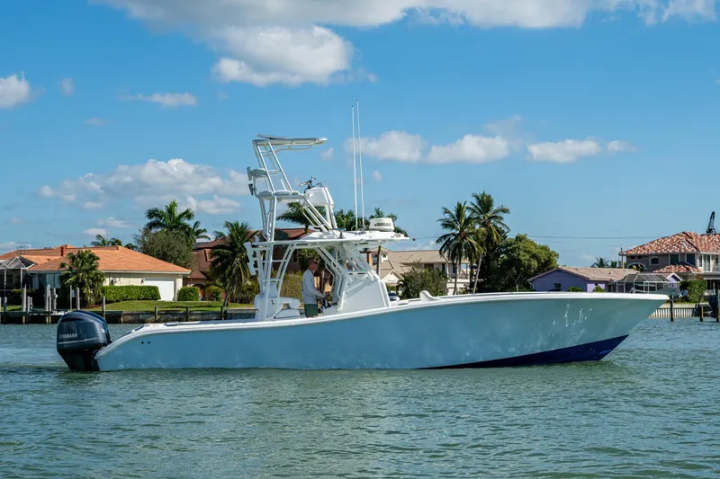 Slide: The Image of 2018 Yellowfin 36 Offshore boat cruising on a sunny day near waterfront homes. - 51
