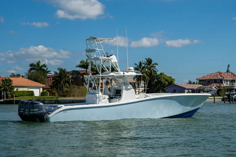 Slide: The Image of 2018 Yellowfin 36 Offshore boat cruising on a sunny day near waterfront homes. - 52