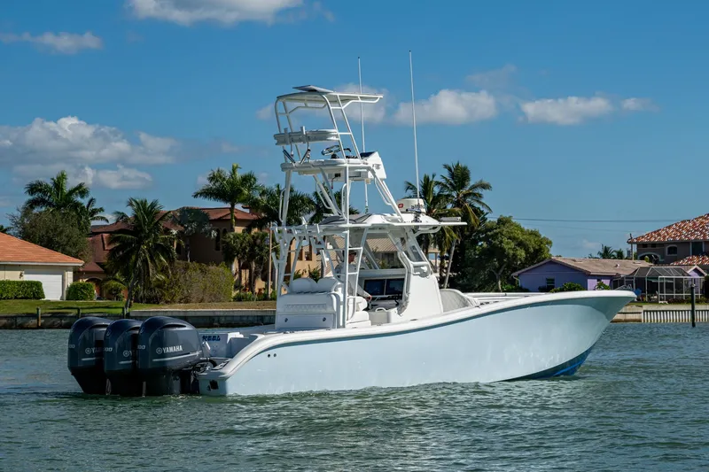 Slide: The Image of 2018 Yellowfin 36 Offshore boat with triple Yamaha engines on a sunny day. - 53