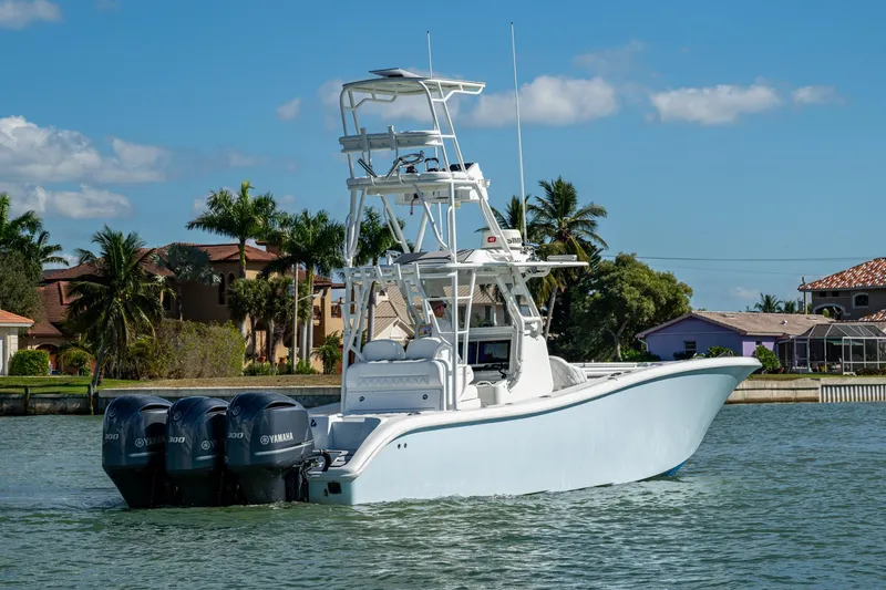 Slide: The Image of 2018 Yellowfin 36 Offshore boat with triple Yamaha engines on a sunny day. - 54