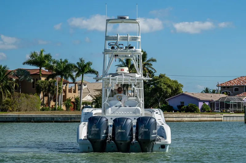 Slide: The Image of 2018 Yellowfin 36 Offshore boat with triple engines on a sunny day. - 56
