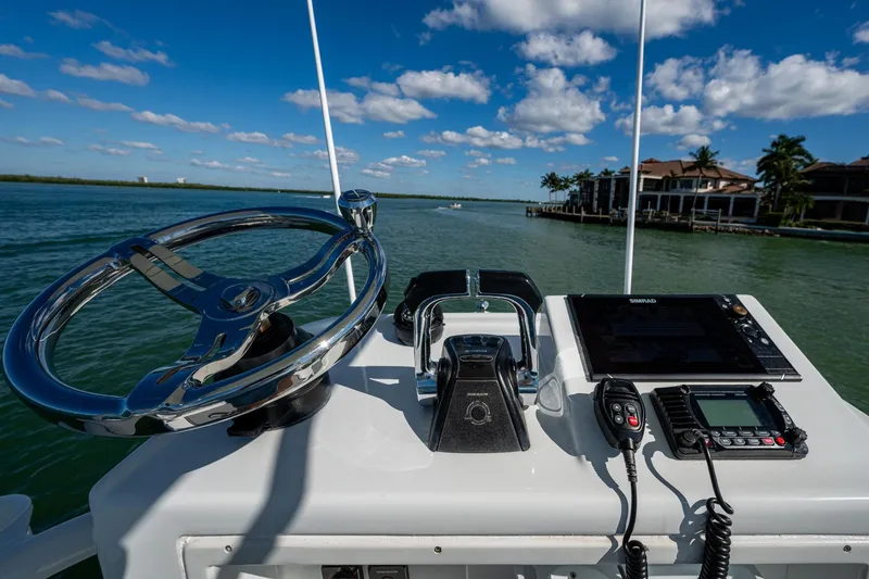 Slide: The Image of 2018 Yellowfin 36 Offshore boat helm with steering wheel and navigation equipment. - 61