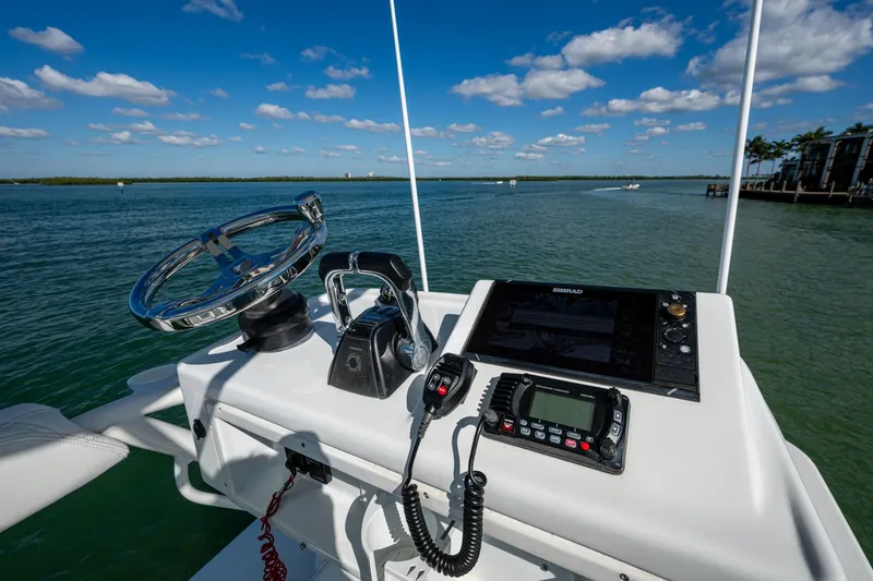 Slide: The Image of 2018 Yellowfin 36 Offshore helm with steering wheel, controls, and navigation system. - 62