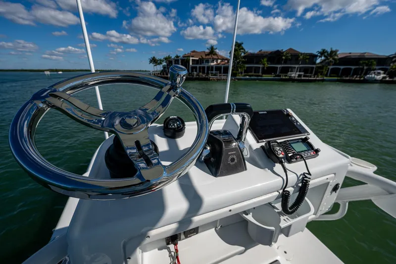 Slide: The Image of 2018 Yellowfin 36 Offshore boat helm with steering wheel and navigation equipment. - 63