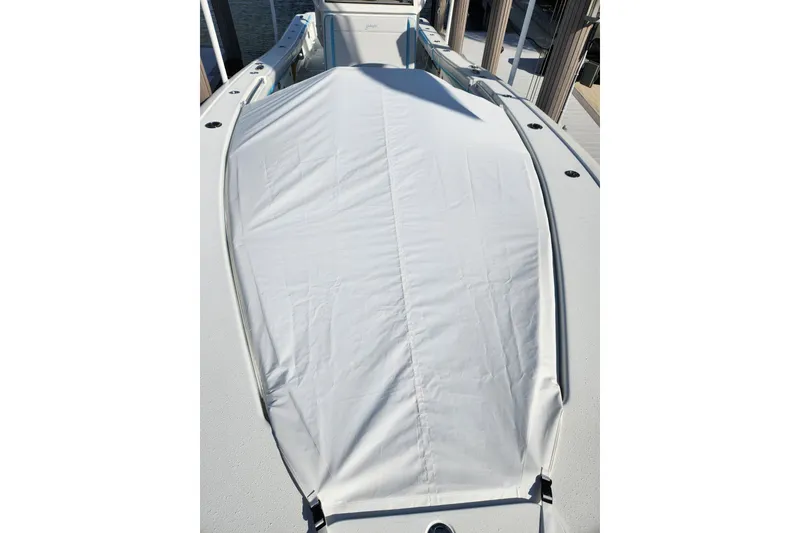 Slide: The Image of 2018 Yellowfin 36 Offshore boat with a white cover on deck. - 65