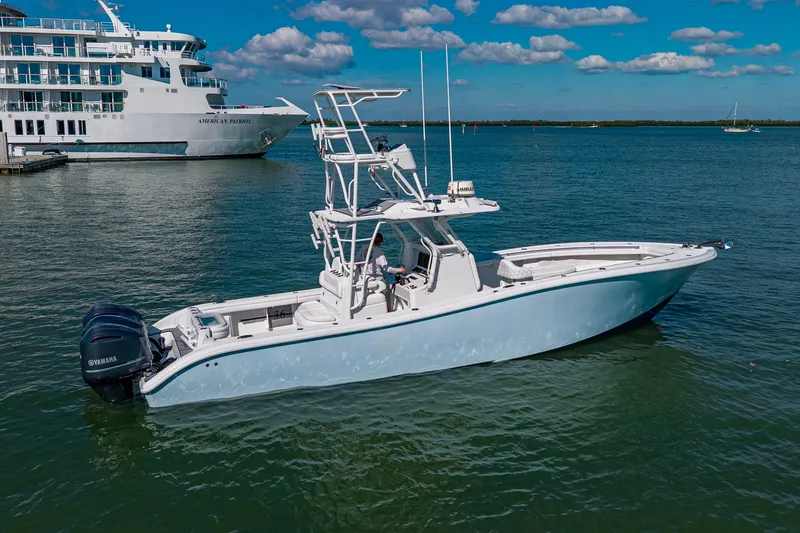 Slide: The Image of 2018 Yellowfin 36 Offshore boat on water, with large ship in background. - 7