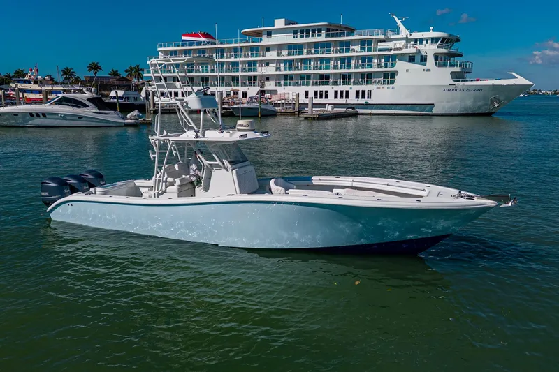 Slide: The Image of 2018 Yellowfin 36 Offshore boat docked near a large cruise ship. - 8