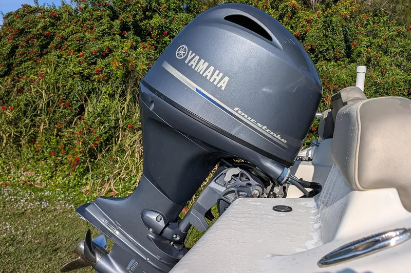 Slide: The Image of 2022 Key West 189 FS boat with Yamaha four-stroke outboard motor, lush greenery background. - 13