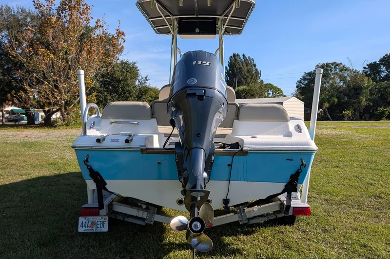 Slide: The Image of 2022 Key West 189 FS boat with outboard motor on grassy area. - 3