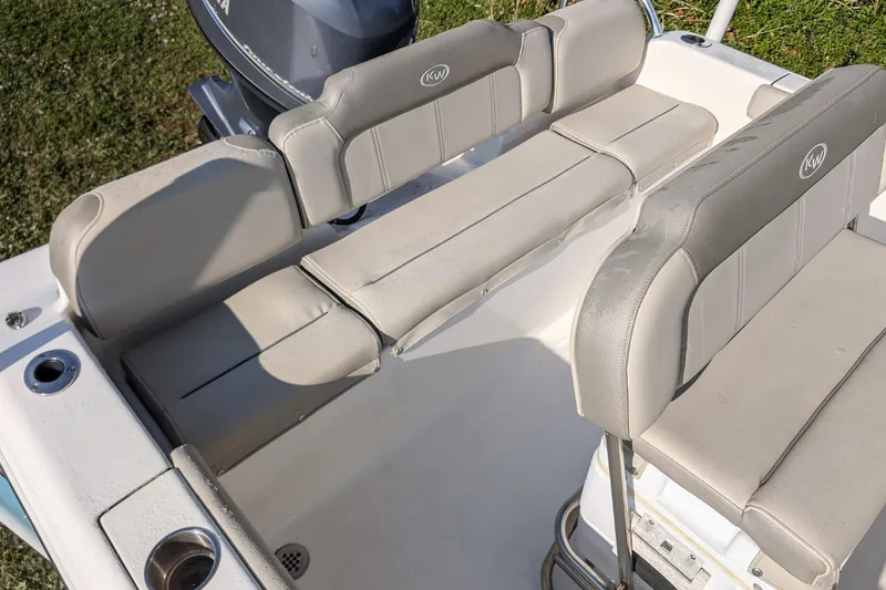 Slide: The Image of 2022 Key West 189 FS boat interior with cushioned seating and cup holders. - 6