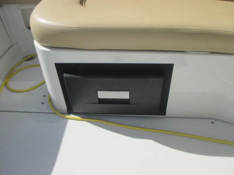 Slide: The Image of 2018 Crownline Eclipse E29 XS boat interior with luxurious seating at a marina. - 12