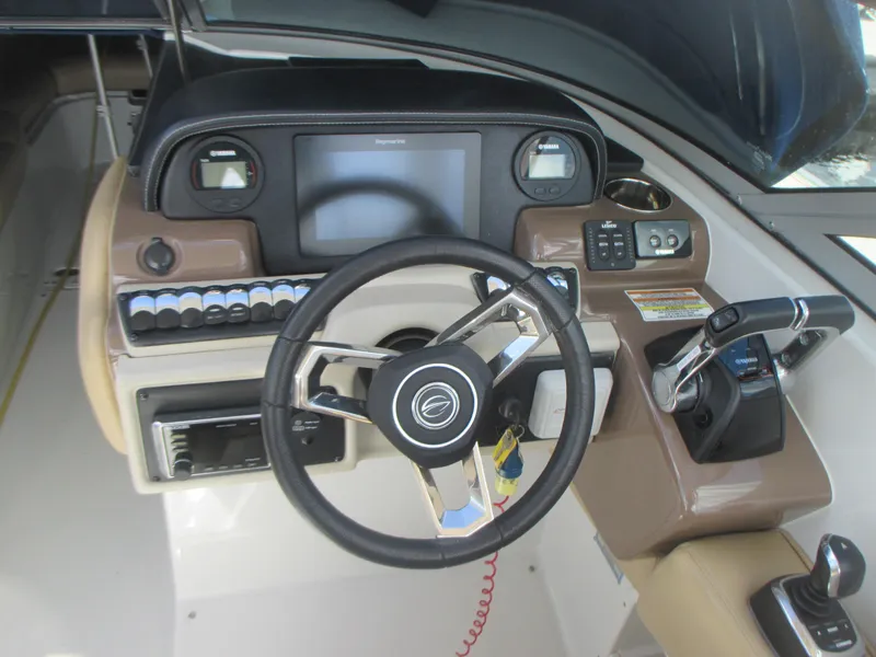 Slide: The Image of Crownline Eclipse E29 XS 2018 boat seating with storage compartment and yellow cable. - 17