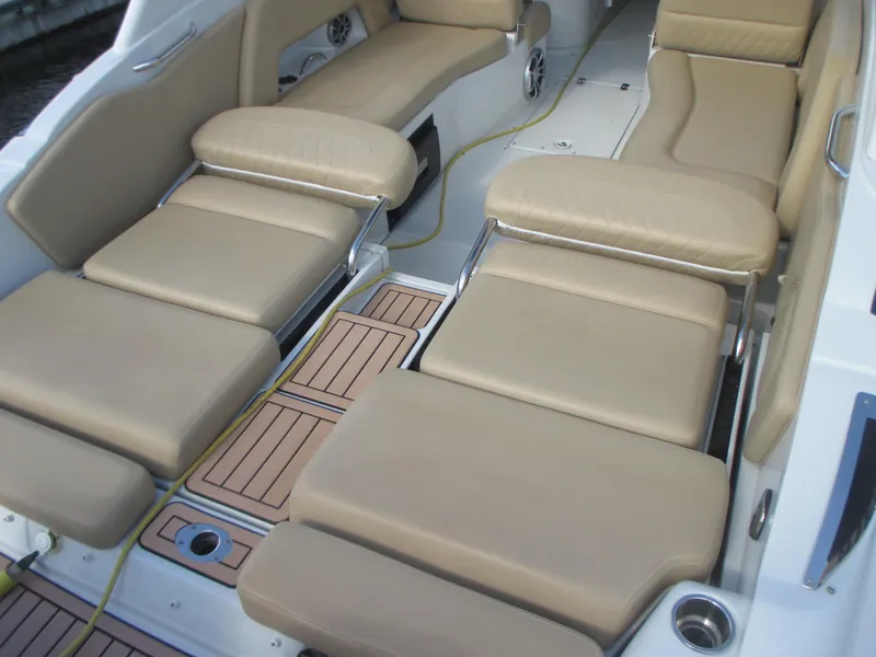 Slide: The Image of 2018 Crownline Eclipse E29 XS boat cockpit with beige seating and steering controls. - 20
