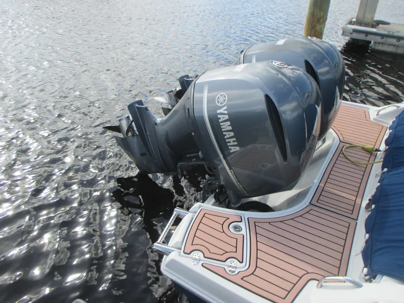 Slide: The Image of 2018 Crownline Eclipse E29 XS boat with dual Yamaha 250 engines docked at marina. - 4