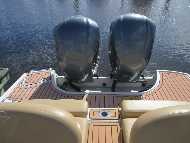 Slide: The Image of 2018 Crownline Eclipse E29 XS boat with dual outboard motors on teak deck. - 6