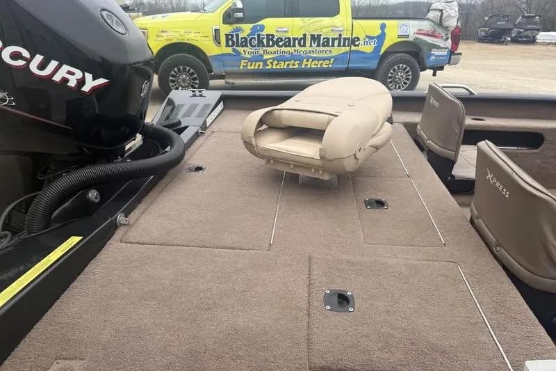 Slide: The Image of 2004 Express x17 boat interior with Mercury engine and beige seating. - 10