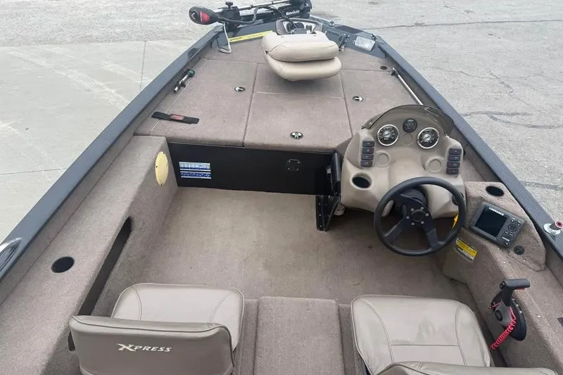 Slide: The Image of 2004 Express x17 boat interior with steering wheel, seats, and control panel. - 11