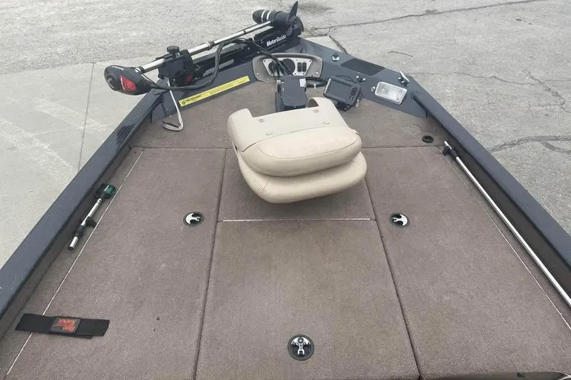 Slide: The Image of 2004 Express x17 boat interior with beige seat and fishing equipment. - 12