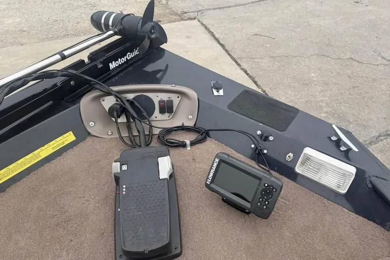 Slide: The Image of Boat dashboard with MotorGuide trolling motor, Lowrance fish finder, and foot pedal controls. - 14