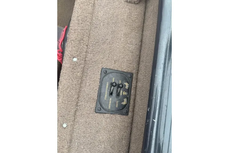 Slide: The Image of 2004 Express x17 boat control panel on carpeted surface. - 15