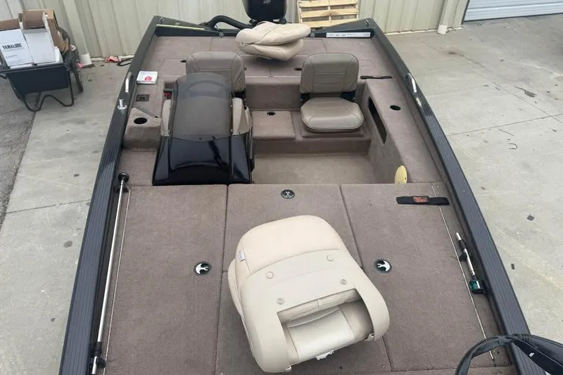 Slide: The Image of 2004 Express x17 boat interior with beige seating and carpeted deck. - 16