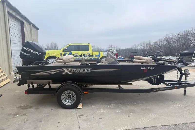 Slide: The Image of 2004 Express x17 boat with Mercury engine on trailer, parked outdoors. - 4