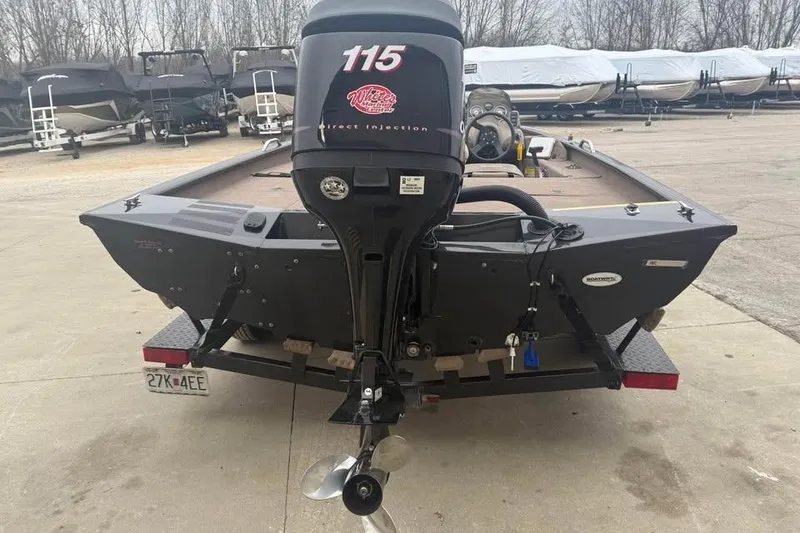 Slide: The Image of 2004 Express x17 boat with 115 horsepower motor, parked on a trailer. - 6