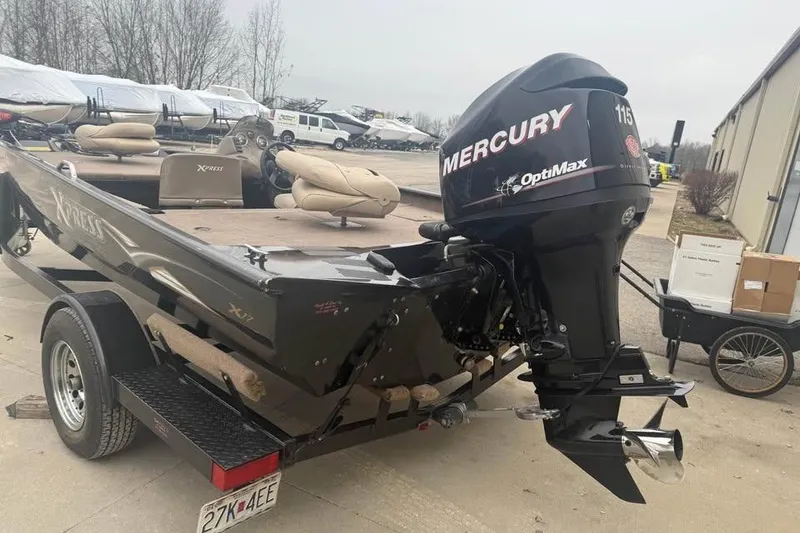 Slide: The Image of 2004 Express x17 boat with Mercury OptiMax 115 outboard motor on trailer. - 7