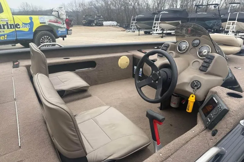 Slide: The Image of 2004 Express x17 boat interior with steering wheel and dashboard controls. - 8